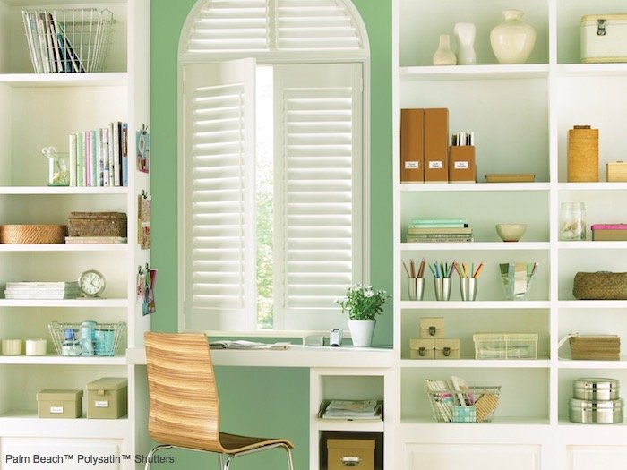 A green painted wall brings the outdoor into this home office. Shown with Palm Beach Polysatin Shutters, available at Dominic's Decorating in Norwalk.