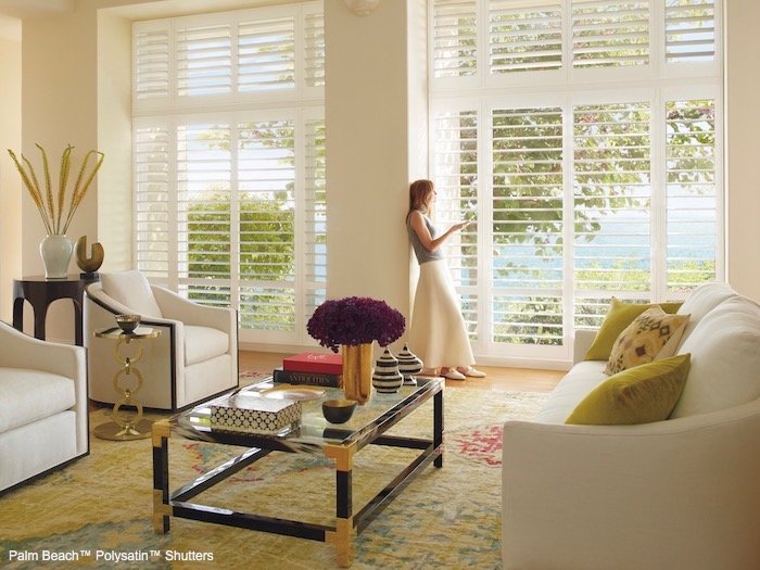A living room with green accents. Shown with Palm Beach Polysatin Shutters; available at Dominic's Decorating in Norwalk